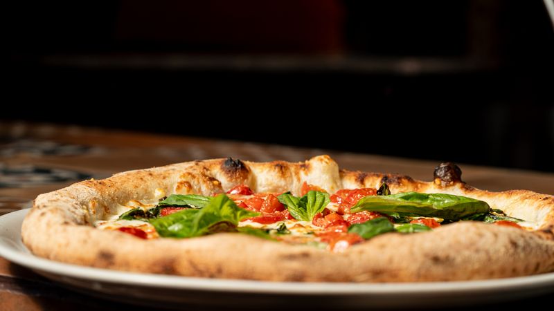 Anthony's coal fired pizza Margherita with fresh basil and tomato